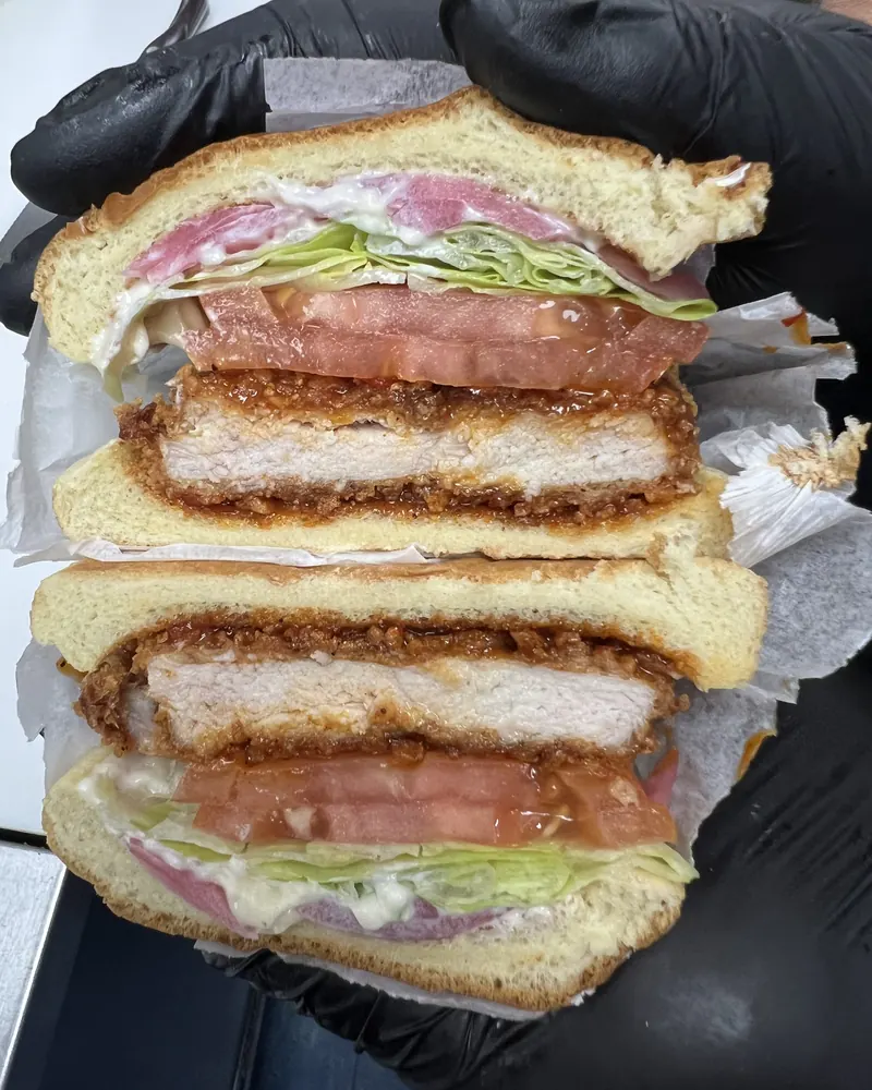 Hot Honey Cutlet sandwich with lettuce, tomato and onion